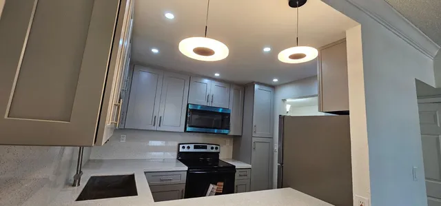 a view of a kitchen with wooden floor and a sink