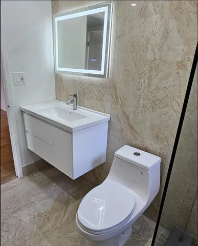 a view of a kitchen with a sink and a refrigerator