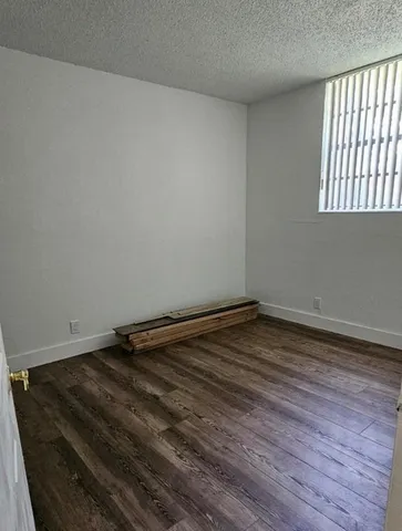 a large kitchen with stainless steel appliances a large counter top