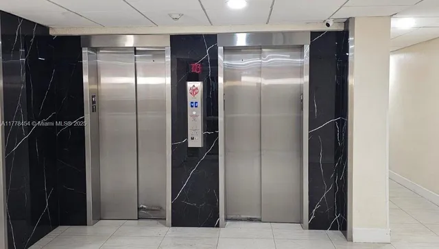 a kitchen with refrigerator and a sink