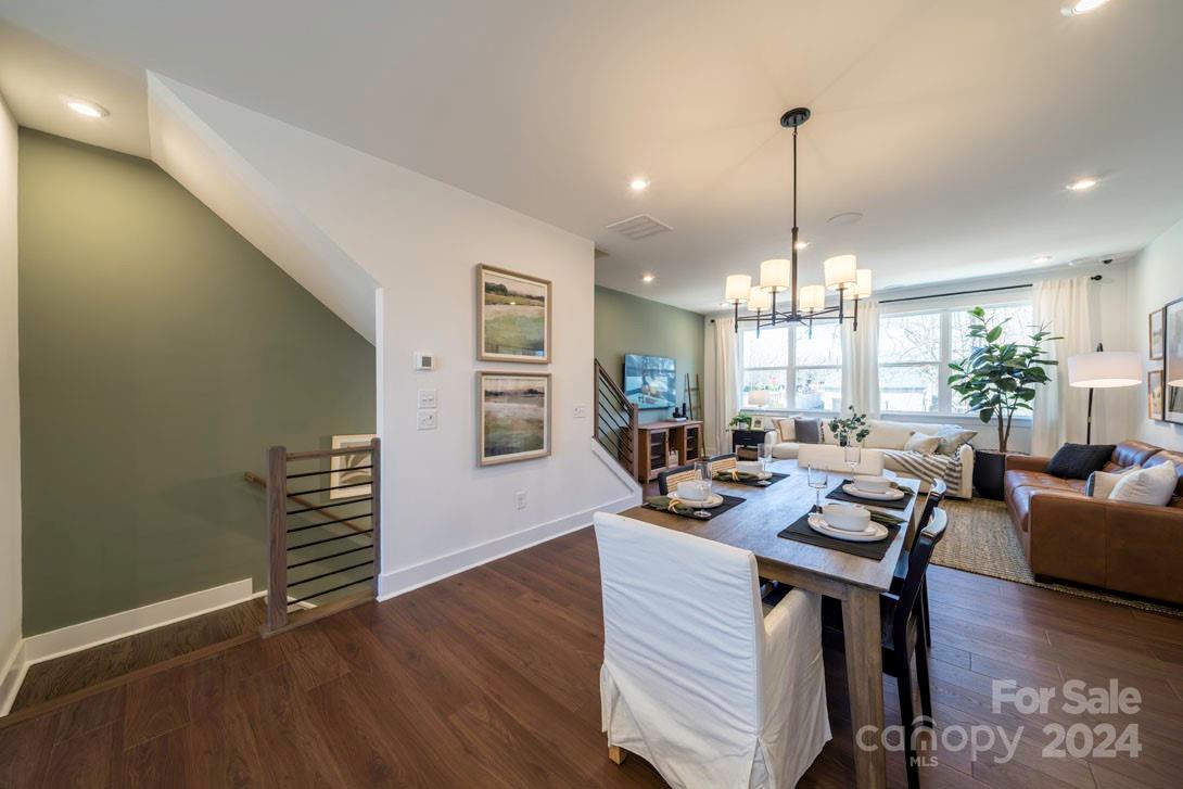 2055 Evolve Way Charlotte, NC 28205 - Photo 17 of 40 a view of a dining room and livingroom with furniture wooden floor a chandelier