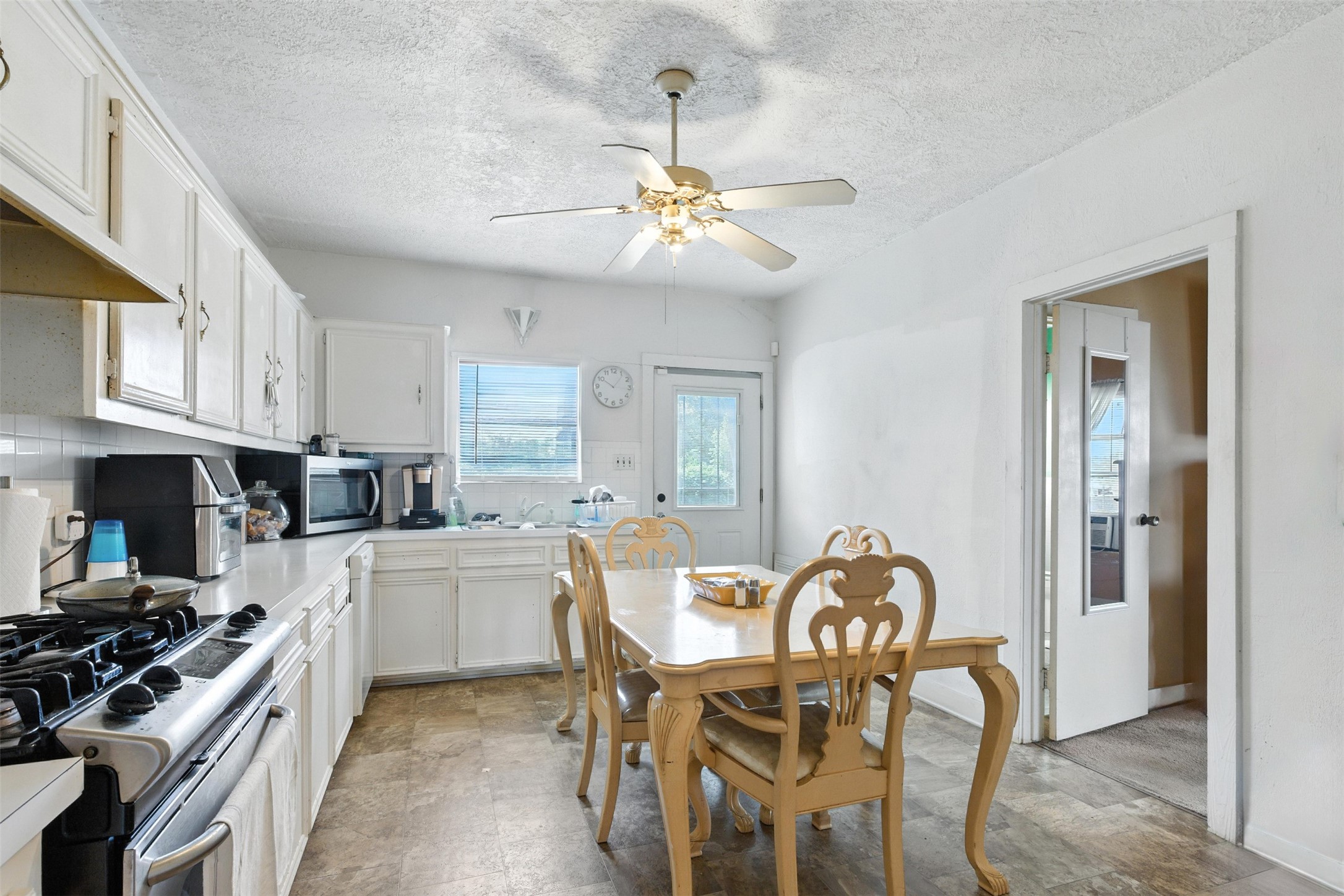 619 10th Street Hempstead, TX 77445 - Photo 11 of 27 a kitchen with stainless steel appliances granite countertop a stove top oven a sink a dining table and chairs