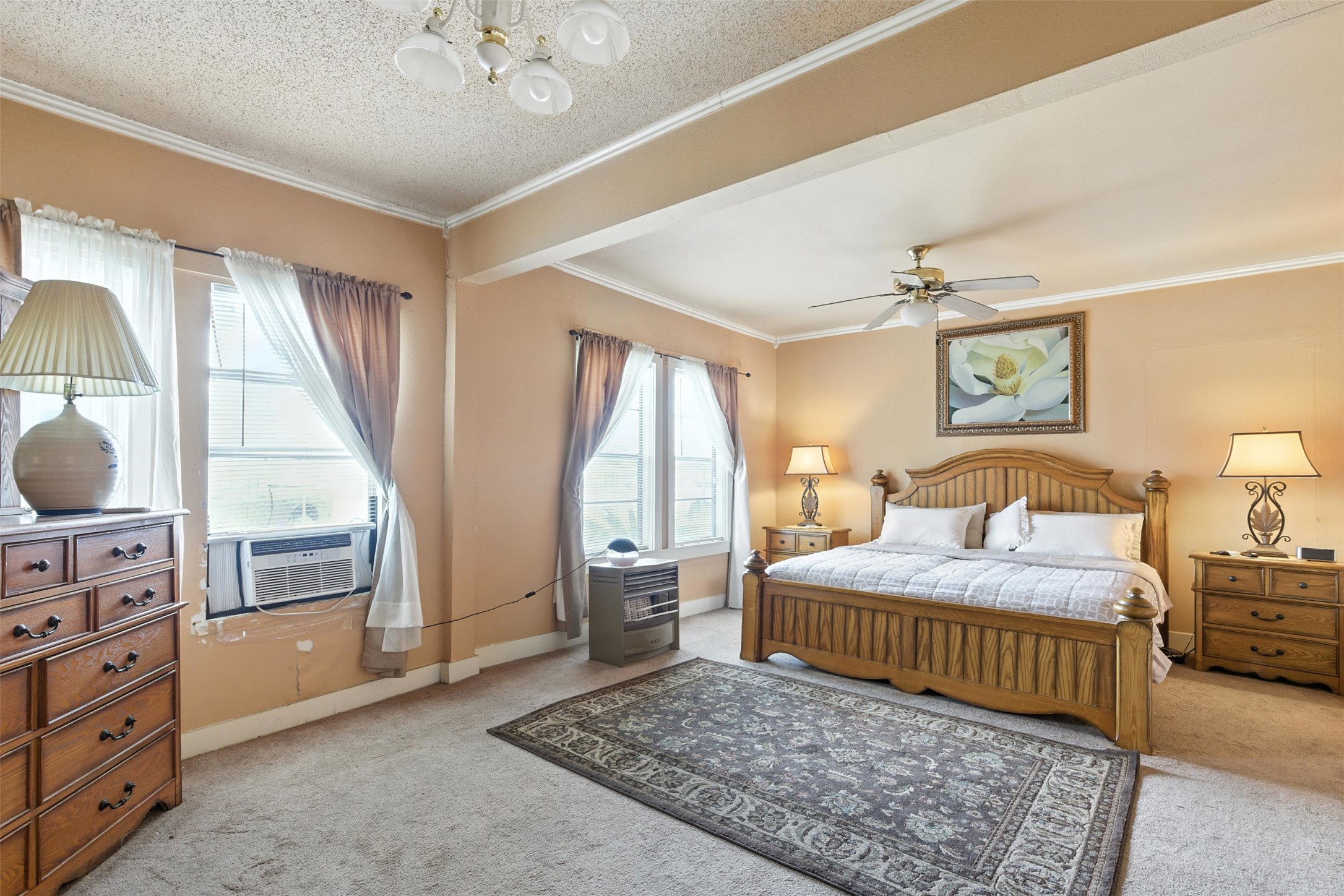 619 10th Street Hempstead, TX 77445 - Photo 13 of 27 a bedroom with a bed and a chandelier