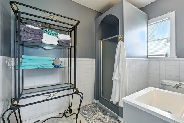 a bathroom with a tub and a shower