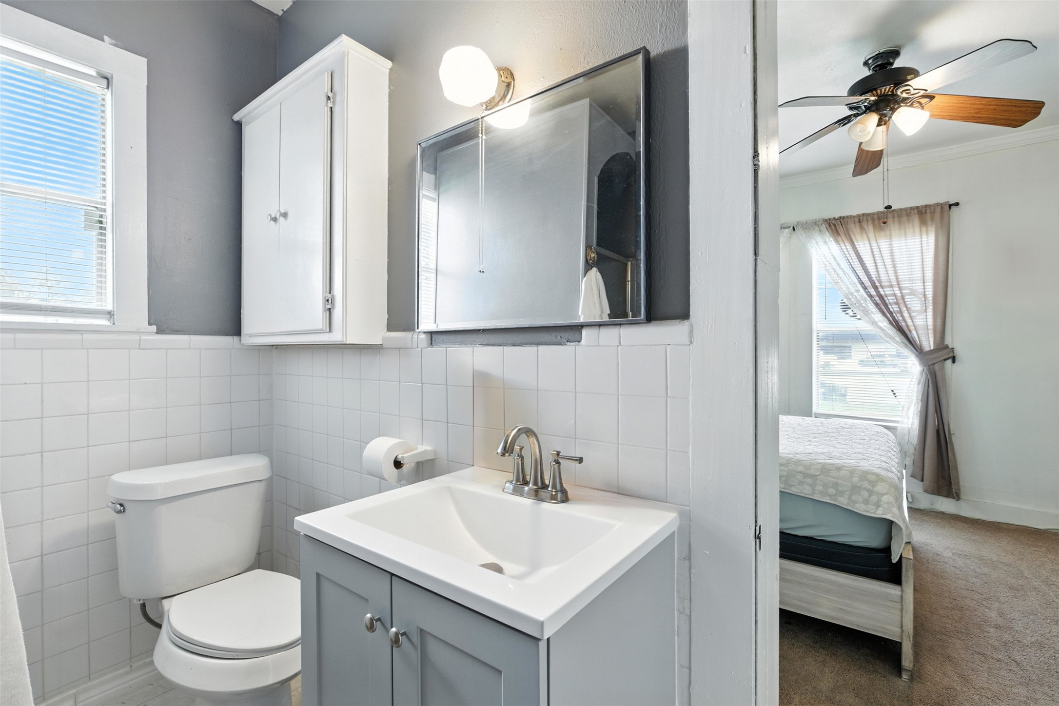 619 10th Street Hempstead, TX 77445 - Photo 7 of 27 a bathroom with a toilet sink and mirror