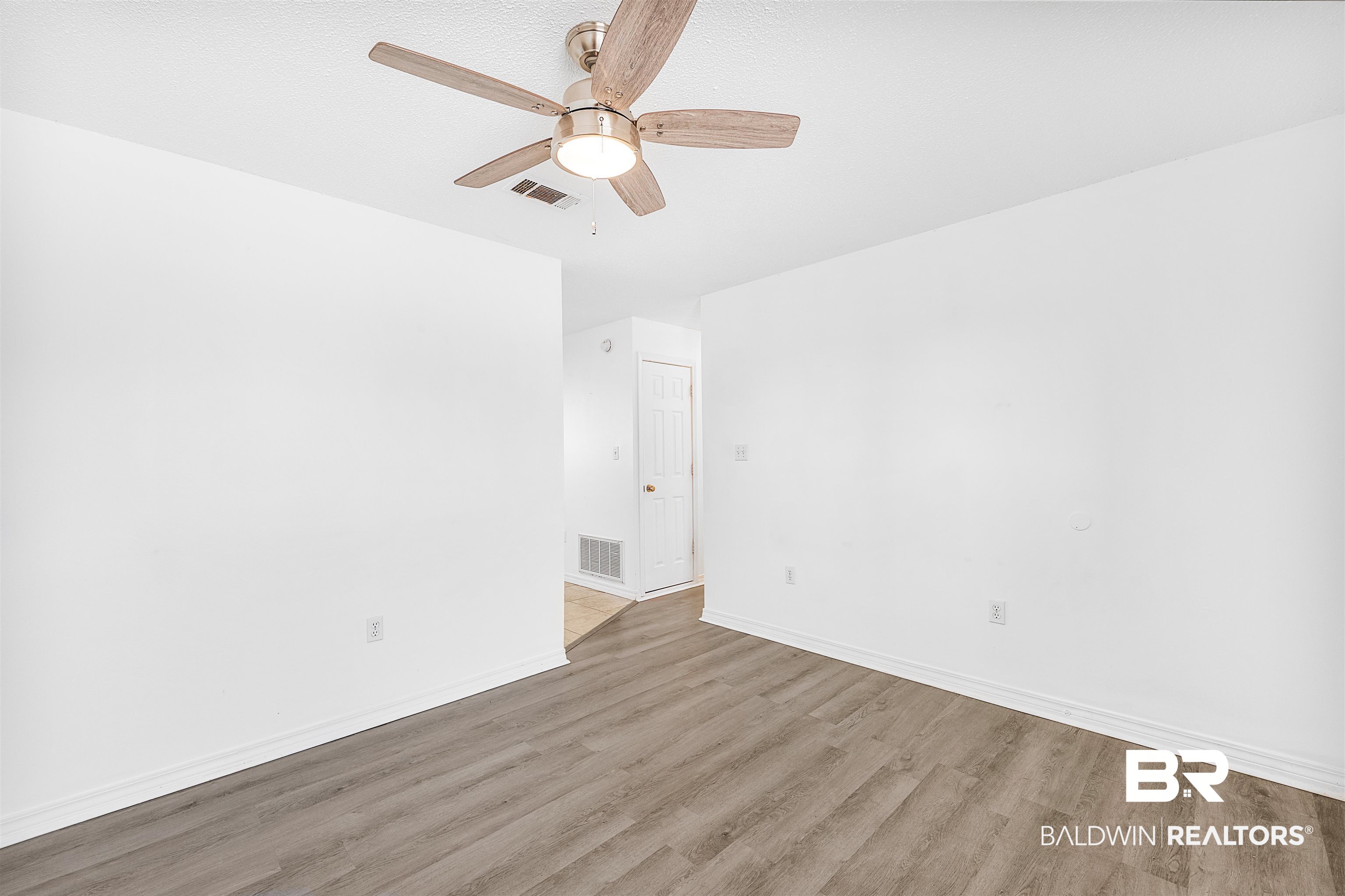14919 Daugherty Road Foley, AL 36535 - Photo 13 of 27 Empty room featuring light hardwood / wood-style floors and ceiling fan