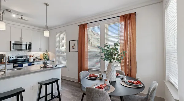 a dining room with furniture and window