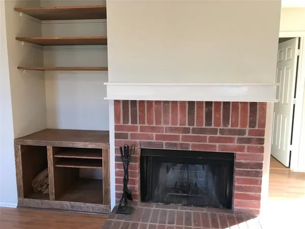 a kitchen with a fireplace and a cabinets