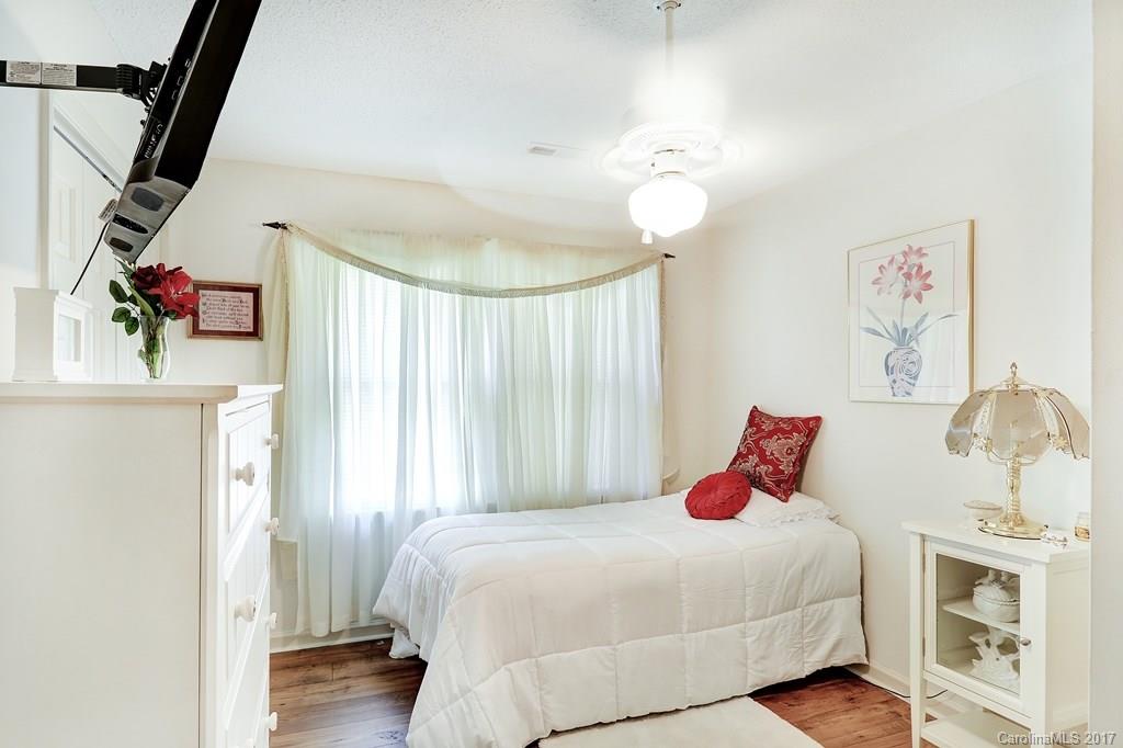 113 Banks Ridge Road Fort Mill, SC 29715 - Photo 15 of 21 a bedroom with a bed and a chandelier