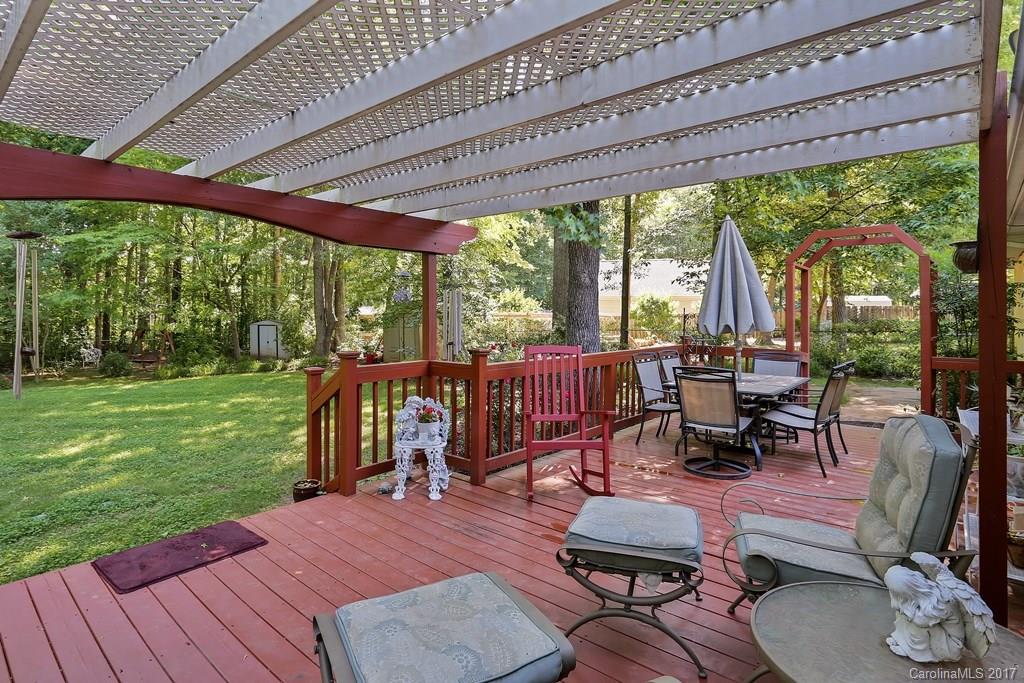 113 Banks Ridge Road Fort Mill, SC 29715 - Photo 16 of 21 a view of a patio with table and chairs potted plants with wooden floor and fence