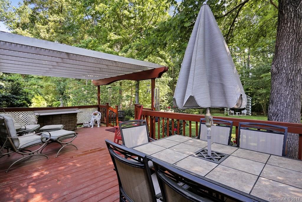113 Banks Ridge Road Fort Mill, SC 29715 - Photo 17 of 21 a view of a patio with table and chairs under an umbrella with wooden floor