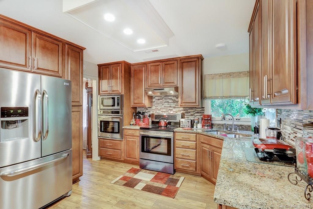 113 Banks Ridge Road Fort Mill, SC 29715 - Photo 7 of 21 a kitchen with stainless steel appliances granite countertop a refrigerator sink and stove
