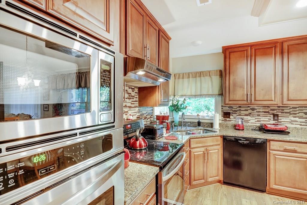 113 Banks Ridge Road Fort Mill, SC 29715 - Photo 8 of 21 a kitchen with stainless steel appliances granite countertop a stove and a sink