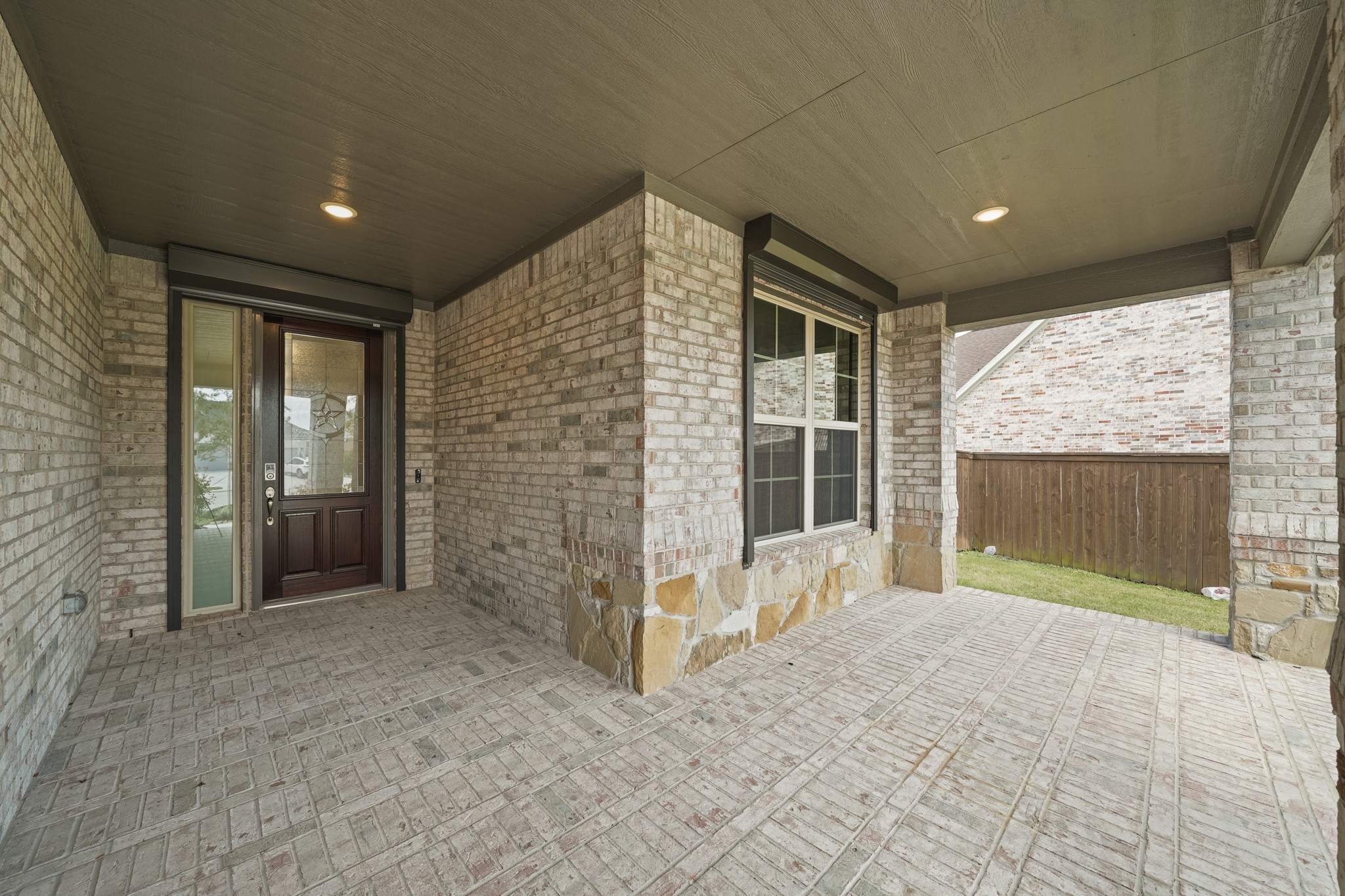 5739 Bobwhite Trail Manvel, TX 77578 - Photo 3 of 29 Enjoy your morning coffee or greet guests from the generous covered front porch, beautifully finished with brick flooring and a striking mahogany entry door.