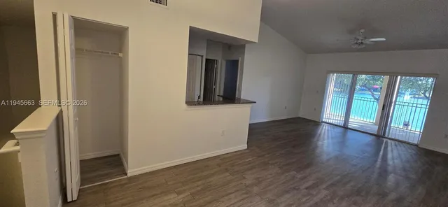 a view of a balcony with wooden floor and fence