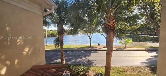 a view of an empty room with wooden floor and closet