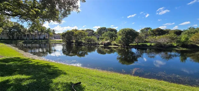 a view of a lake with houses in the background