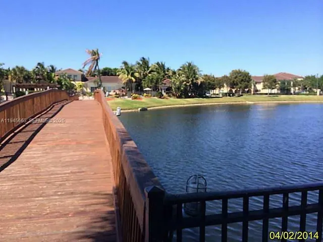 a view of swimming pool with outdoor seating and yard in the back