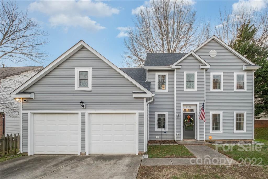 7201 Reedy Creek Road Charlotte, NC 28215 - Photo 1 of 30 a front view of a house with a yard and garage