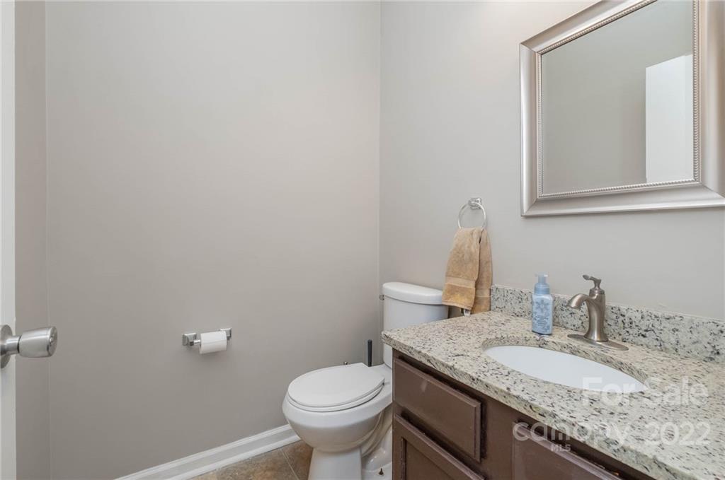 7201 Reedy Creek Road Charlotte, NC 28215 - Photo 17 of 30 a bathroom with a granite countertop sink and a mirror