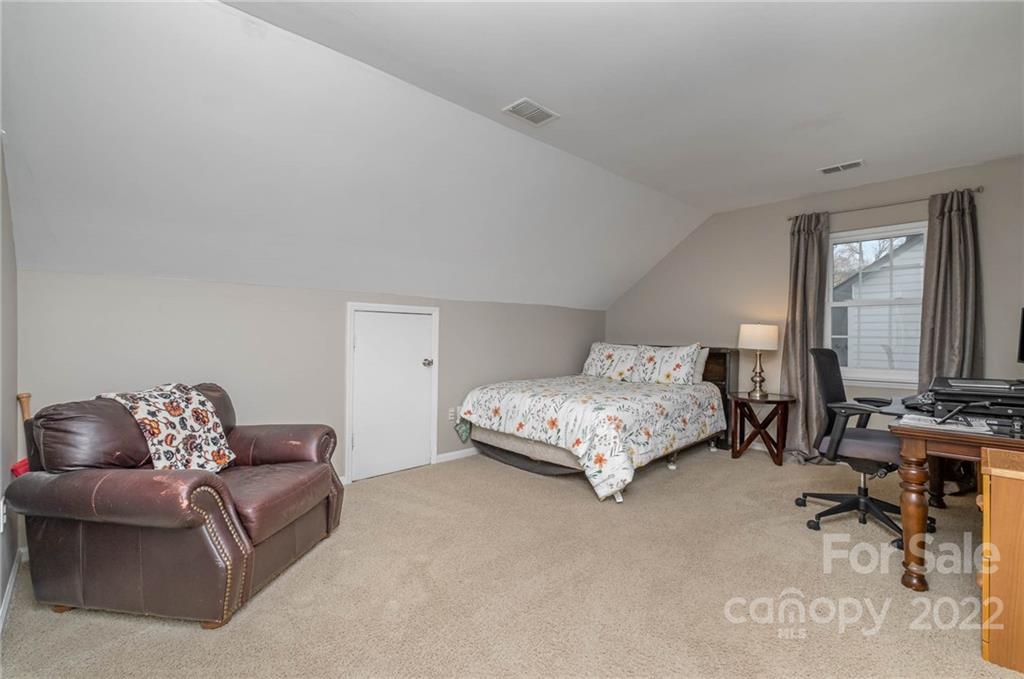 7201 Reedy Creek Road Charlotte, NC 28215 - Photo 27 of 30 a bedroom with furniture and a couch