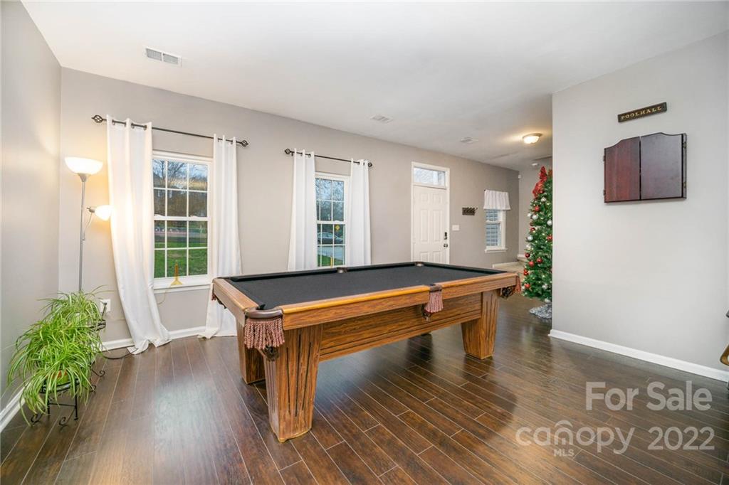 7201 Reedy Creek Road Charlotte, NC 28215 - Photo 5 of 30 a room with wooden floor and pool table