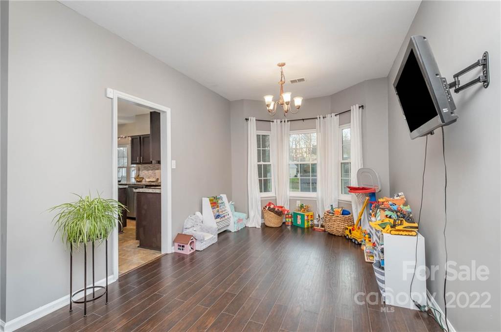7201 Reedy Creek Road Charlotte, NC 28215 - Photo 7 of 30 a view of a room with wooden floor and toys
