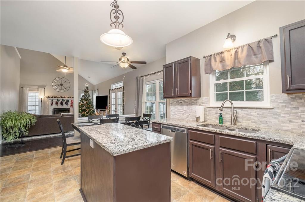 7201 Reedy Creek Road Charlotte, NC 28215 - Photo 8 of 30 a kitchen with granite countertop a sink stove and cabinets