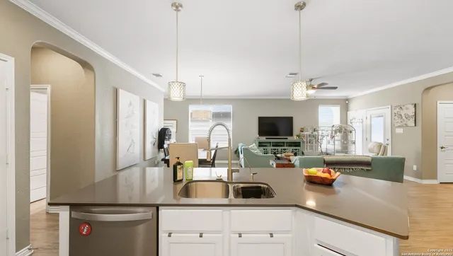 a kitchen with sink refrigerator and cabinets