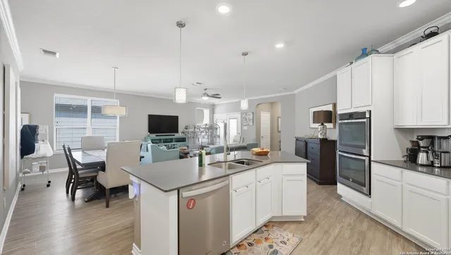 a kitchen with refrigerator and cabinets