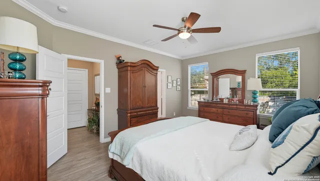 a bedroom with a large bed and a chandelier