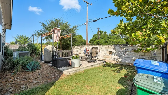 a view of a chairs and table in backyard
