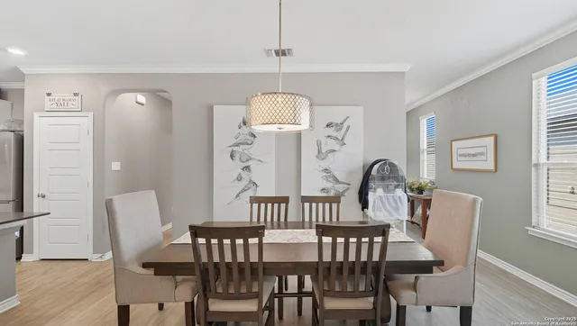 a view of a dining room with furniture and window