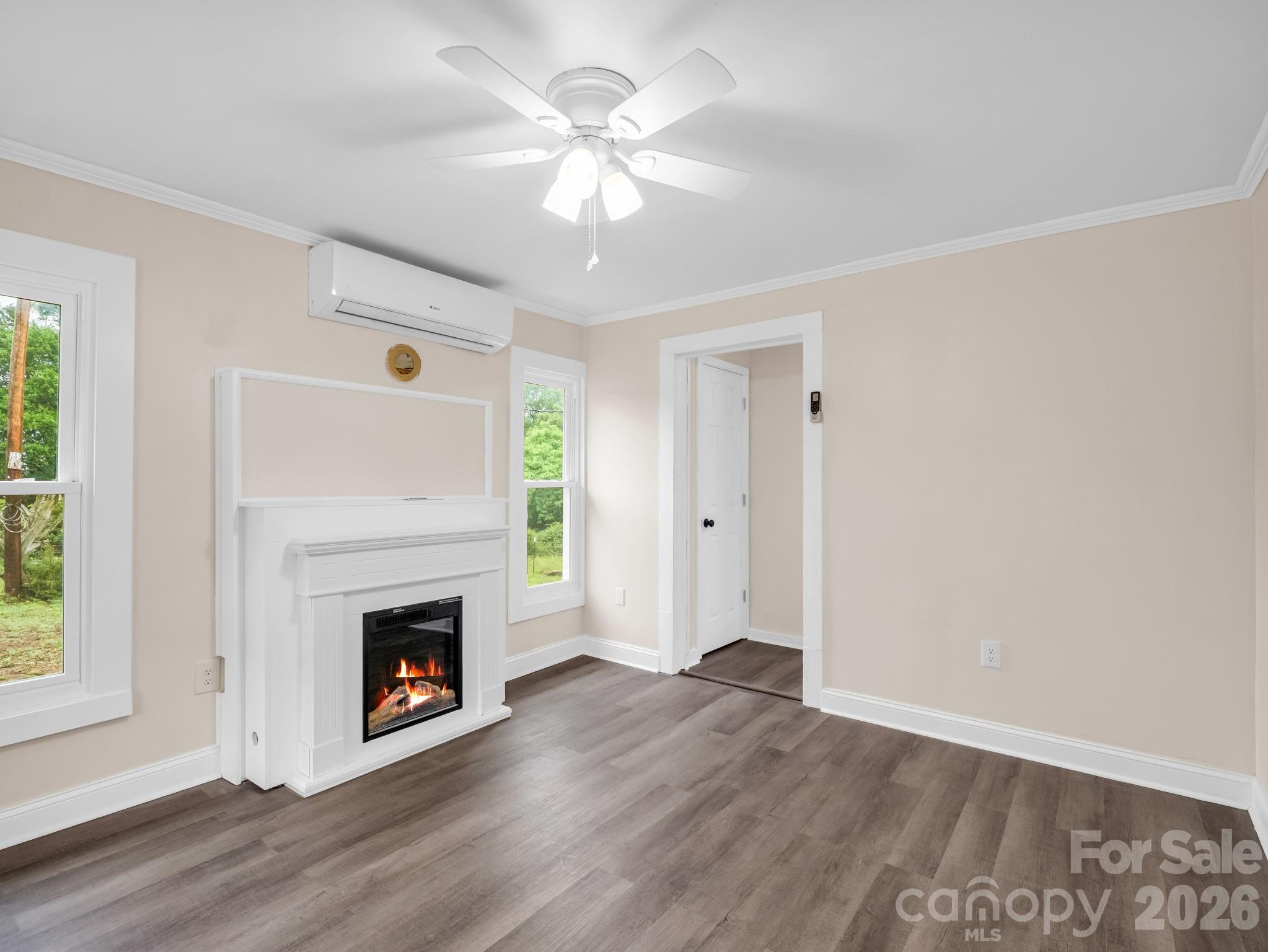 170 Dobbins Road Ellenboro, NC 28040 - Photo 14 of 32 a view of a livingroom with a fireplace a ceiling fan and windows