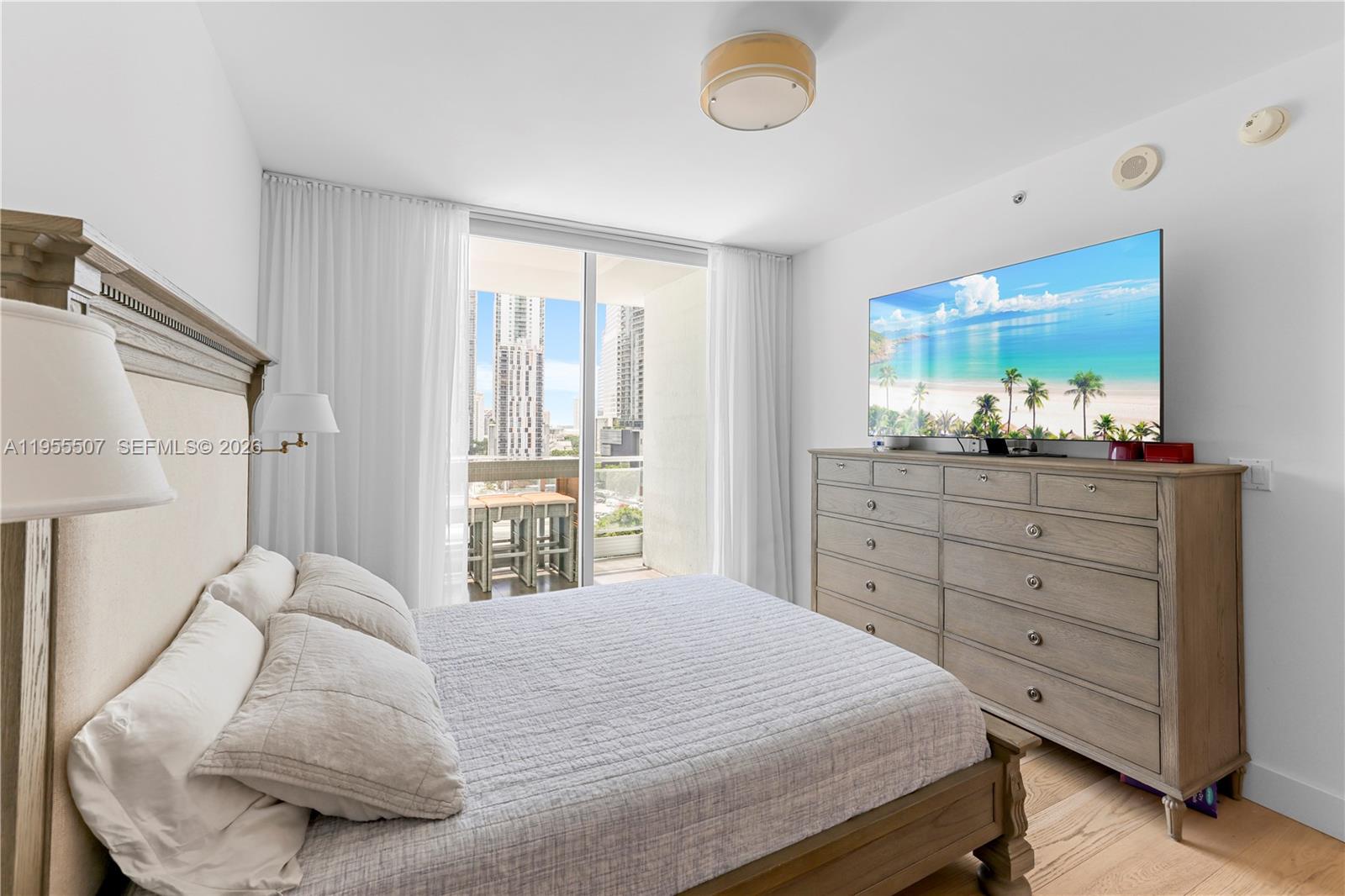 92 Southwest 3rd Street, Unit 1201 Miami, FL 33130 - Photo 16 of 31 a bedroom with a bed and window