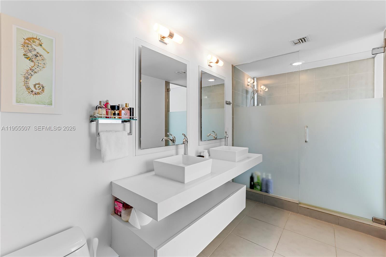 92 Southwest 3rd Street, Unit 1201 Miami, FL 33130 - Photo 18 of 31 a bathroom with a sink and a mirror