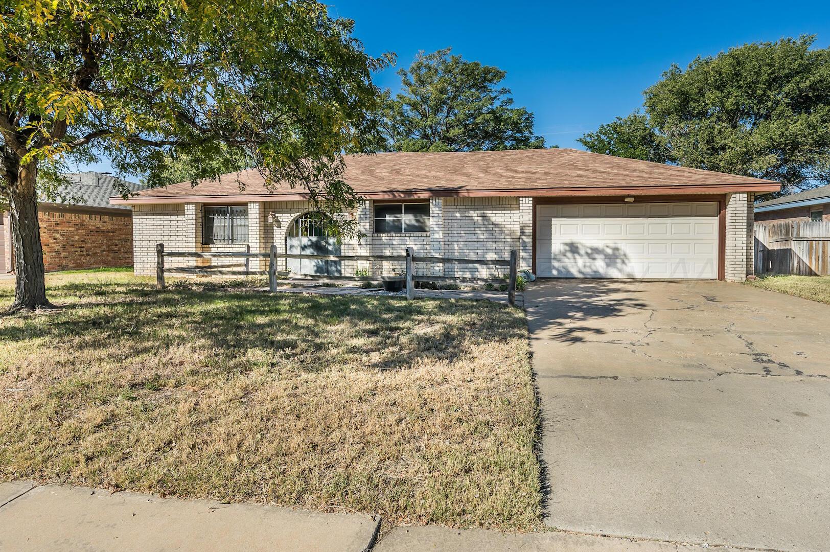 4502 Harvard Street Amarillo, TX 79109 - Photo 1 of 26 a front view of a house with yard covered with trees