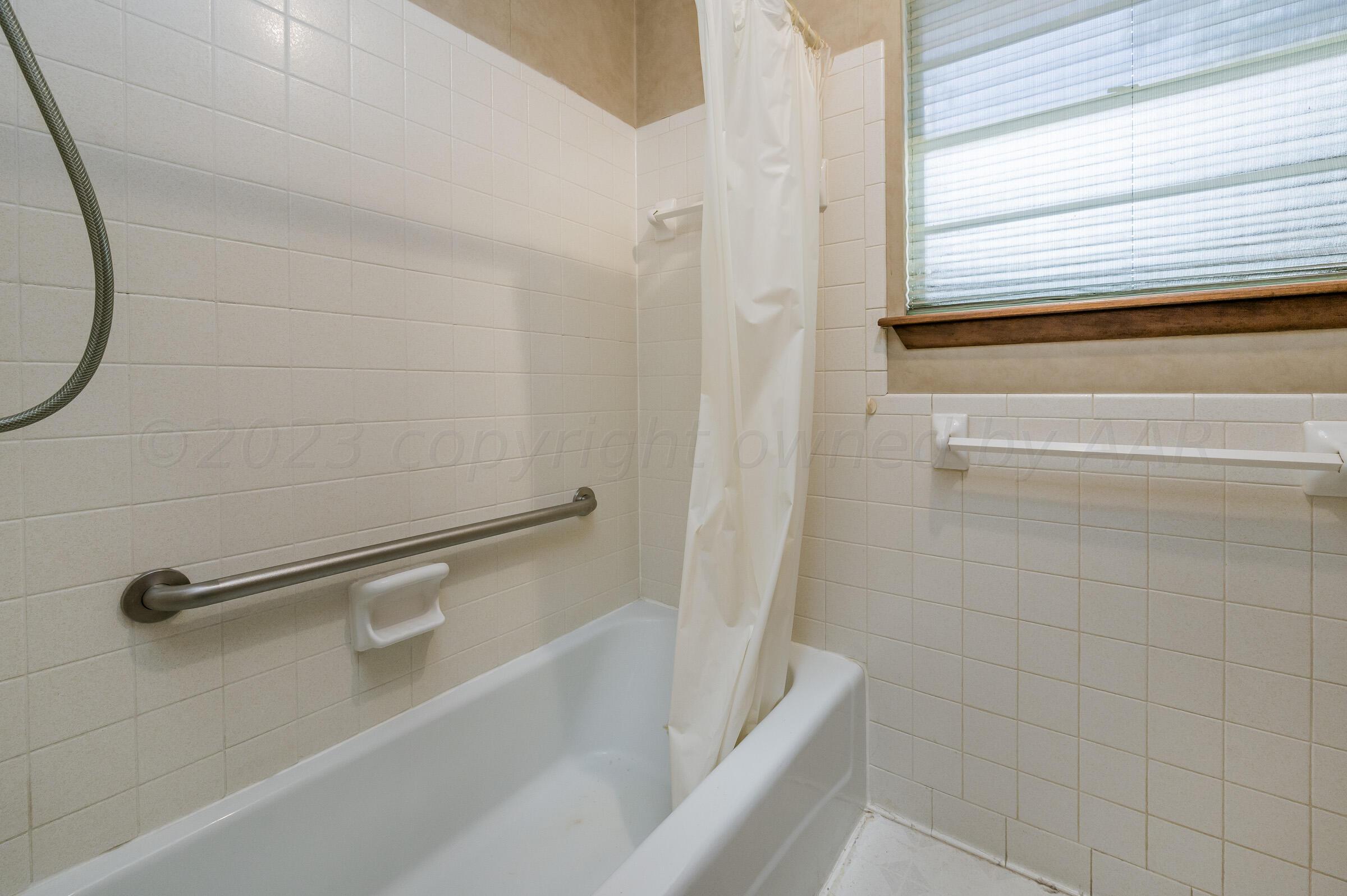 4502 Harvard Street Amarillo, TX 79109 - Photo 15 of 26 a bathroom with a shower