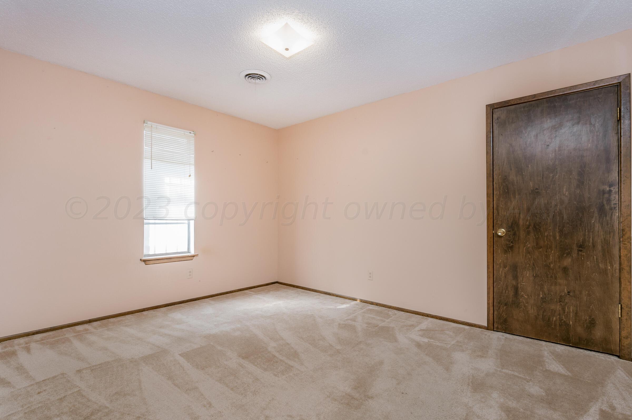 4502 Harvard Street Amarillo, TX 79109 - Photo 17 of 26 an empty room with windows