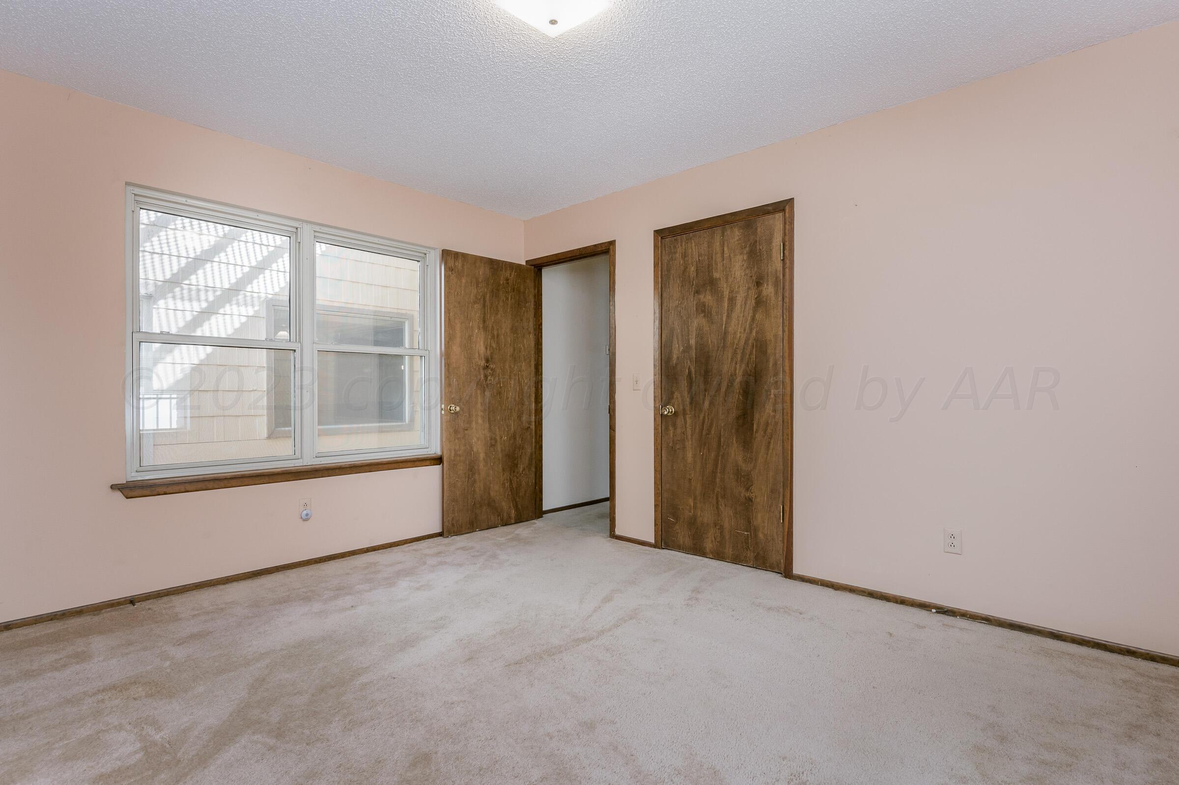 4502 Harvard Street Amarillo, TX 79109 - Photo 18 of 26 a view of an empty room with a window