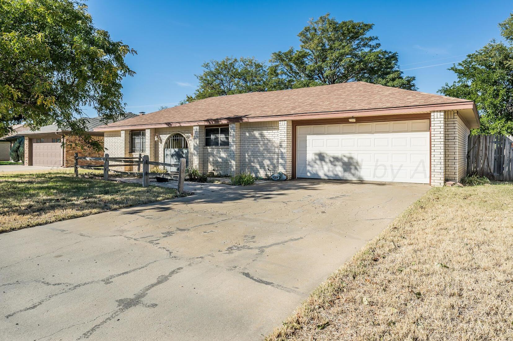 4502 Harvard Street Amarillo, TX 79109 - Photo 2 of 26 a front view of a house with a yard