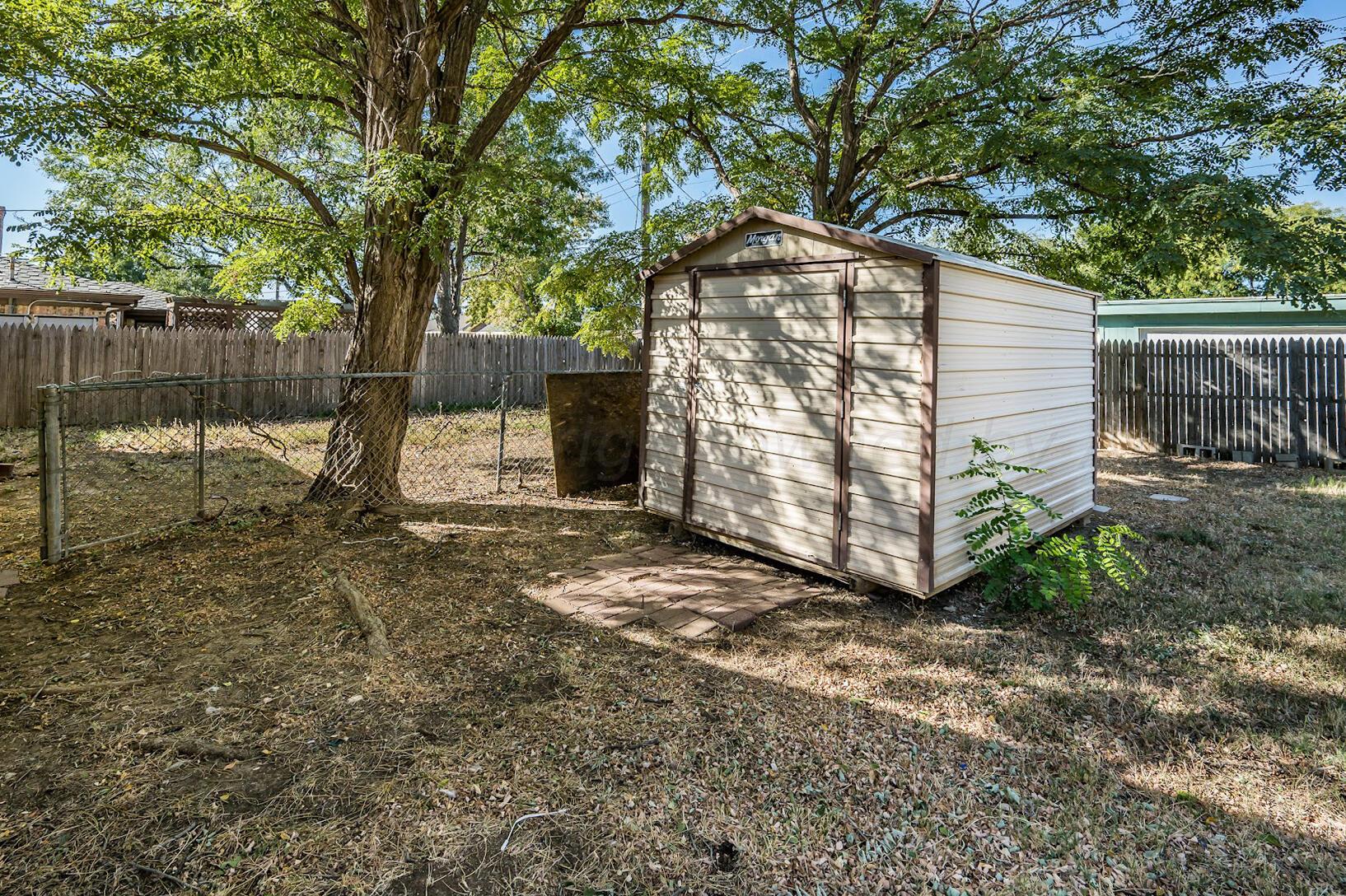 4502 Harvard Street Amarillo, TX 79109 - Photo 26 of 26 a view of a wooden door with a trees