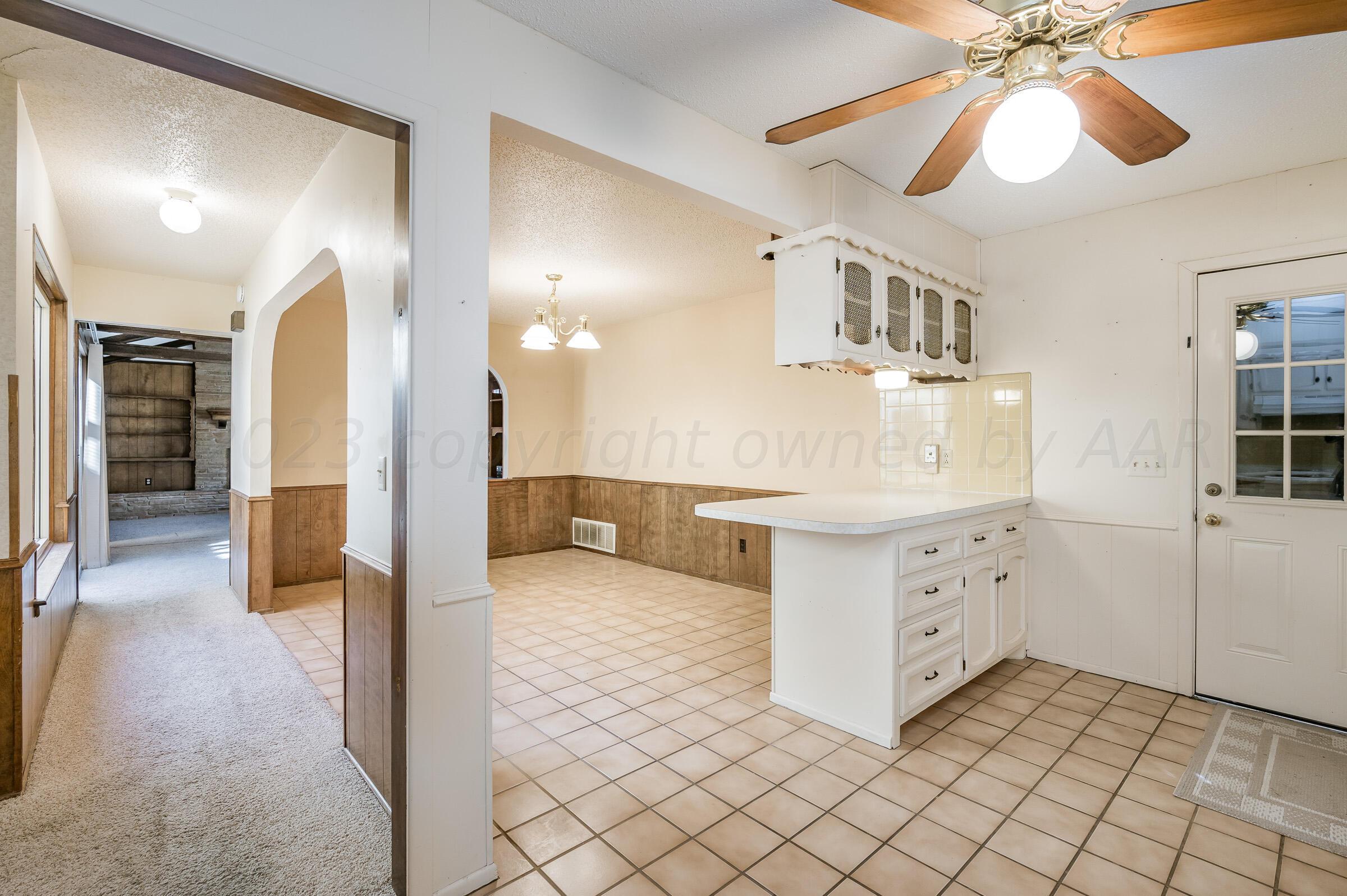 4502 Harvard Street Amarillo, TX 79109 - Photo 6 of 26 a kitchen with granite countertop a sink and a stove top oven