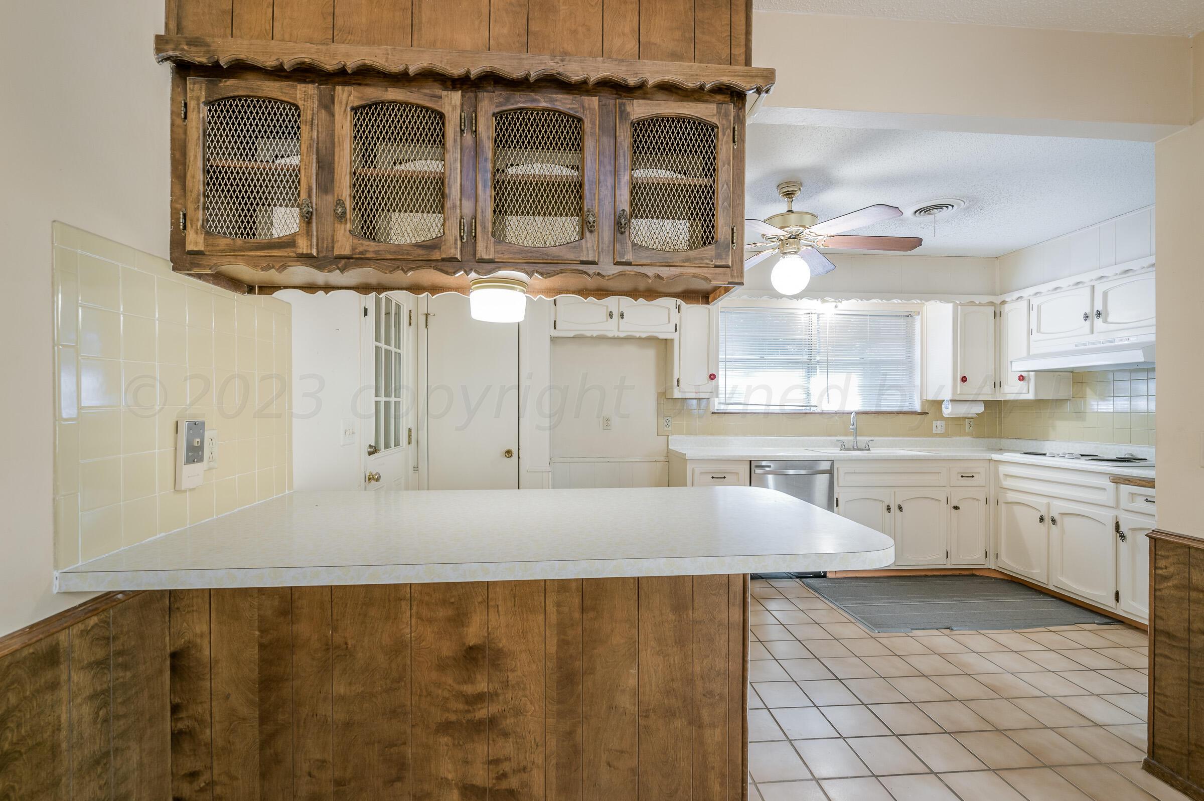 4502 Harvard Street Amarillo, TX 79109 - Photo 7 of 26 a kitchen with a stove a sink and cabinets