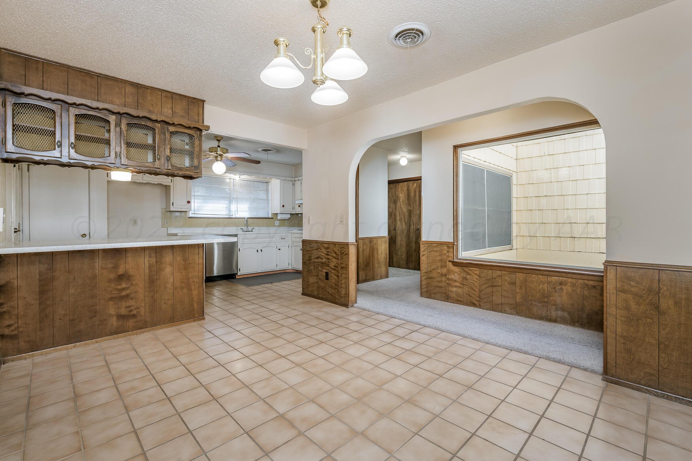 4502 Harvard Street Amarillo, TX 79109 - Photo 8 of 26 a kitchen with stainless steel appliances granite countertop a sink and cabinets