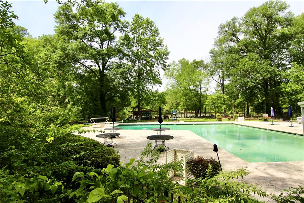 6380 River Chase Circle Northwest Sandy Springs, GA 30328 - Photo 16 of 25 a view of a swimming pool and a yard