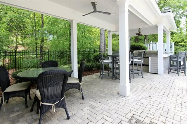 a view of a porch with furniture and a yard