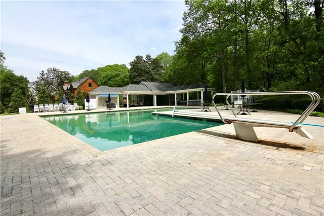 a view of a house with a yard and sitting area