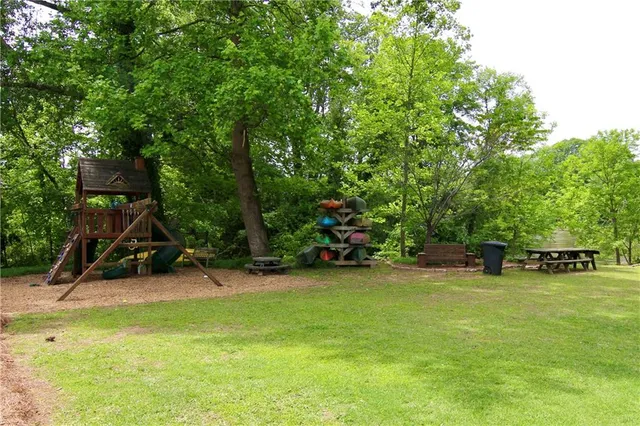 a view of a backyard with swimming pool