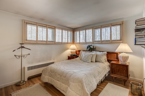 9 Wheeler Road Lexington, MA 02420 - Photo 21 of 30 a bedroom with a bed and a lamp